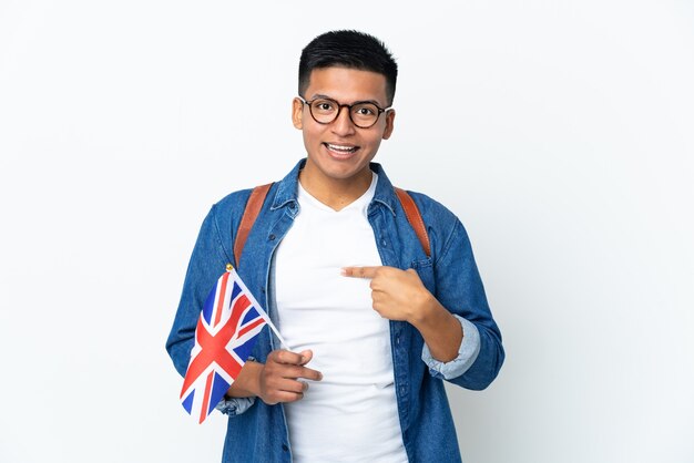 Young Ecuadorian woman holding an United Kingdom flag isolated on white wall with surprise facial expression