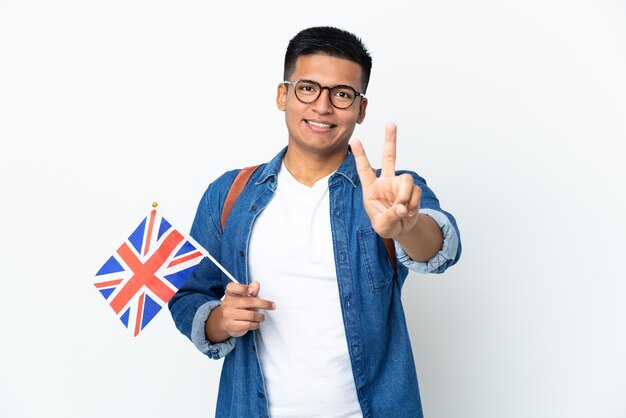 Young Ecuadorian woman holding an United Kingdom flag isolated