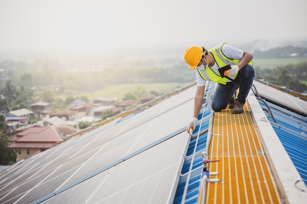 Young electrical engineer Work in a photovoltaic power plant Checking solar panel quality And control the electricity in the building by a photovoltaic system technician