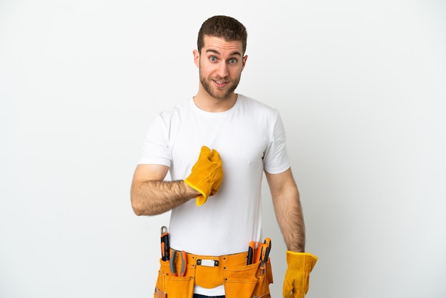 Young electrician man over isolated white wall with surprise facial expression