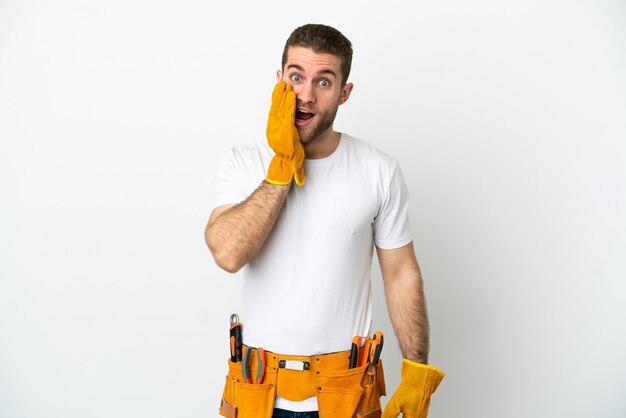 Young electrician man over isolated white wall with surprise and shocked facial expression