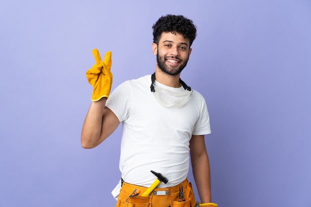 Young electrician Moroccan man isolated