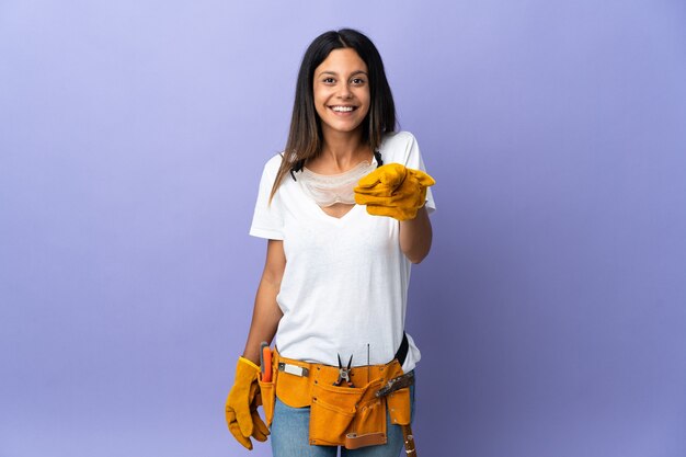 Young electrician woman isolated