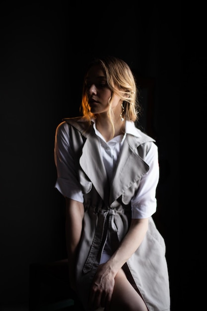 Young elegant fashion female dramatic studio portrait Beautiful blonde girl on black background