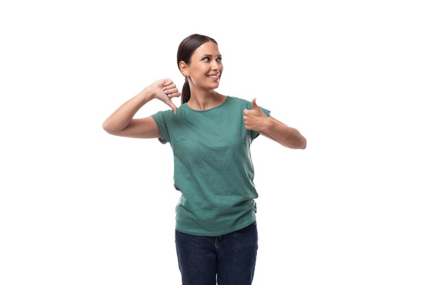 Young emotional brunette woman in tshirt and jeans shows like and dislike