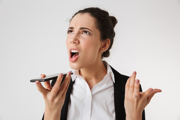 Young emotional screaming business woman talking by phone.