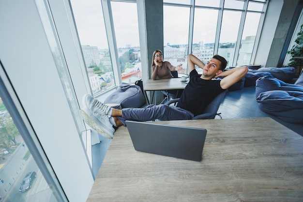 A young employee manager is resting at the workplace near the\
laptop hard working day in the office