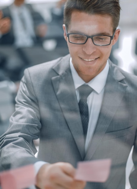 Young employee reading a note on the glass