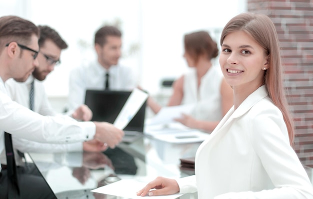 Young employee sitting at his Desk and looking at the camera