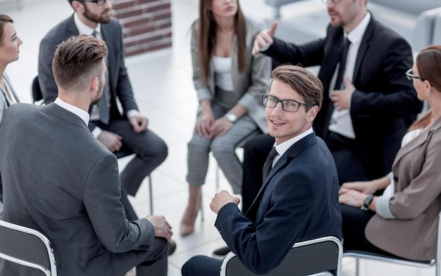 Young employee sitting at a seminar on team buildingbusiness concept