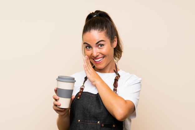 Young employee woman holding a take away coffee whispering something