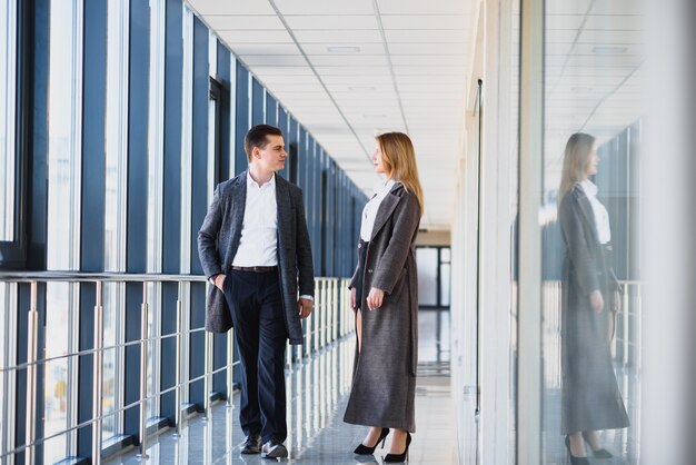 Young employees moving down office center