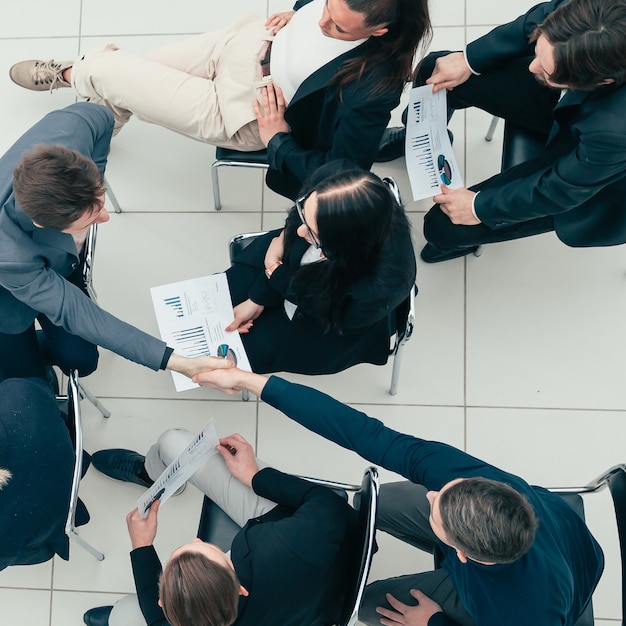 Young employees supporting each other with a handshake