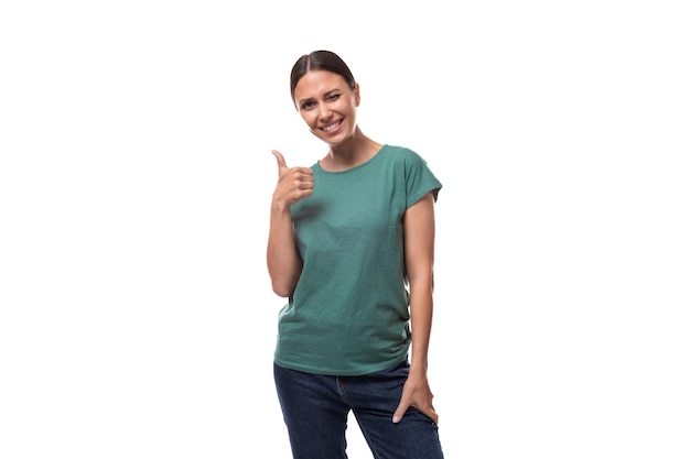 Young energetic slim european woman with ponytail hairstyle dressed in green tshirt looks confident