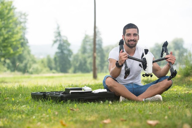 Young Engineer Man Prepares a Drone to Flight in Park