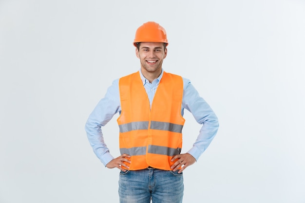 Photo young engineer smiling isolated on white background.