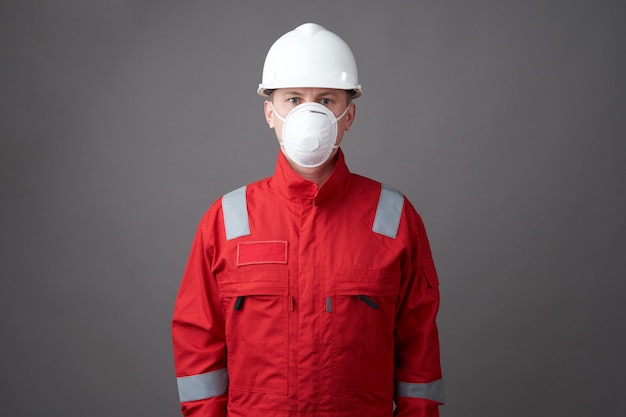 Young engineer worker wear a helmet, face mask