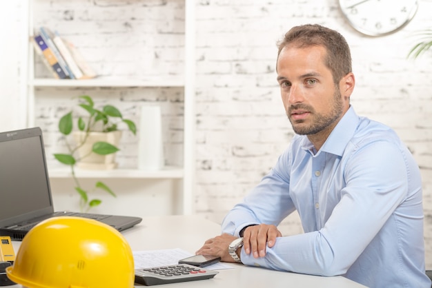 Young engineer working in his office