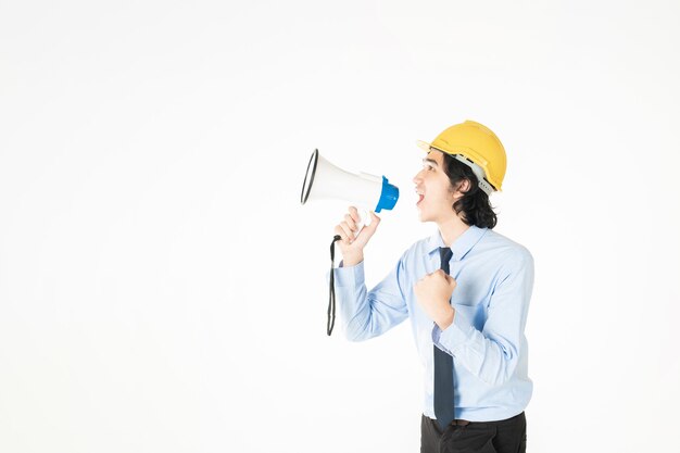 Young engineering man is announcing with megaphone 