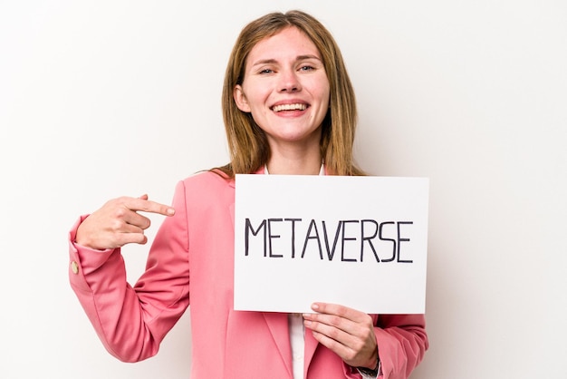 Young English business woman holding a metaverse placard isolated on white background person pointing by hand to a shirt copy space, proud and confident