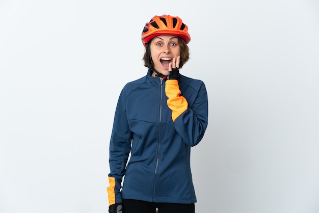 Young English cyclist woman isolated on white wall with surprise and shocked facial expression