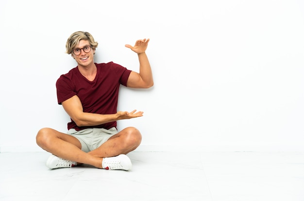 Young English man sitting on the floor