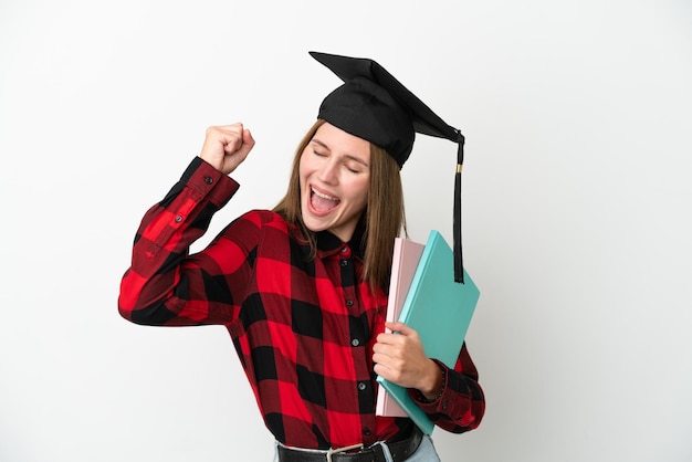 Photo young english student woman isolated on white background celebrating a victory