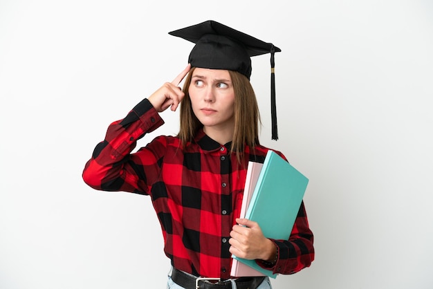 Young English student woman isolated on white background having doubts and thinking