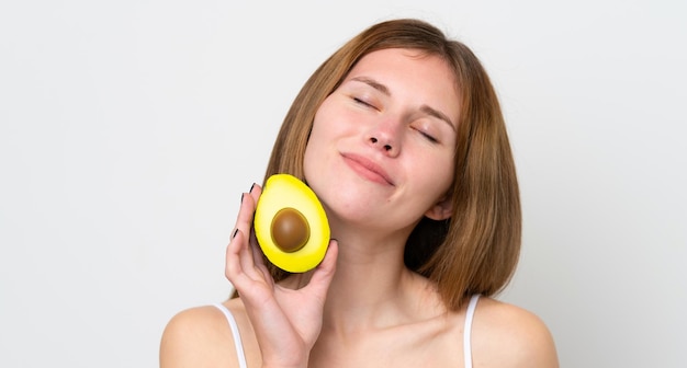 Young English woman holding an avocado Close up portrait