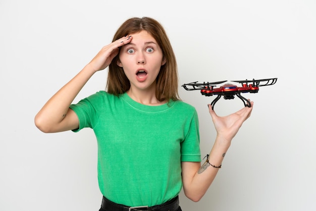 Young English woman holding a drone isolated on white background with surprise expression