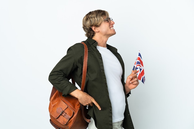 Young English woman holding an United Kingdom flag suffering from back ache