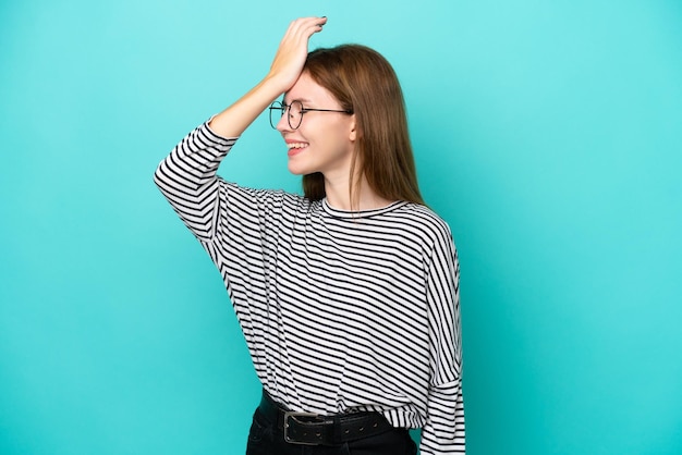 Young English woman isolated on blue background has realized something and intending the solution