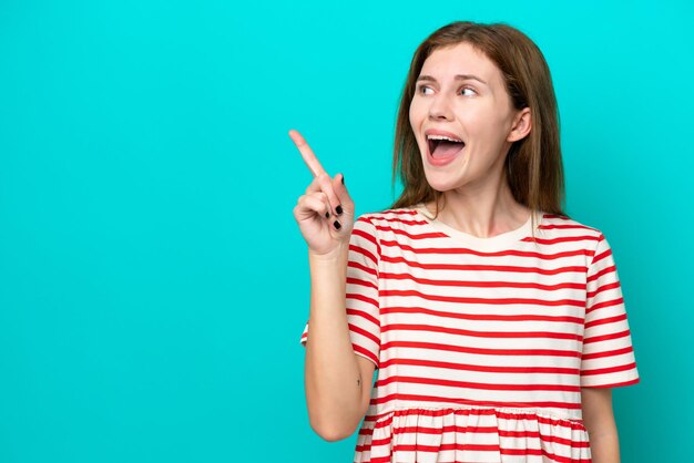 Young English woman isolated on blue background intending to realizes the solution while lifting a finger up