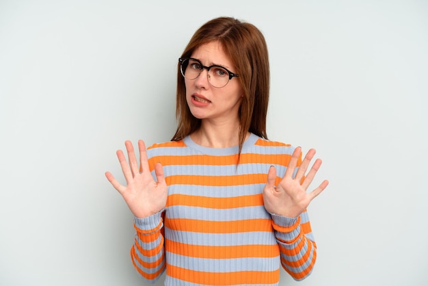 Young English woman isolated on blue background rejecting someone showing a gesture of disgust.