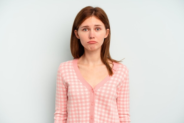 Photo young english woman isolated on blue background sad, serious face, feeling miserable and displeased.