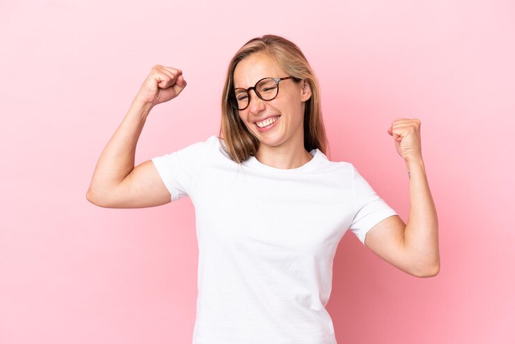 Photo young english woman isolated on pink background celebrating a victory