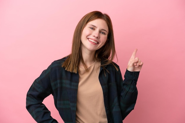 Young English woman isolated on pink background showing and lifting a finger in sign of the best