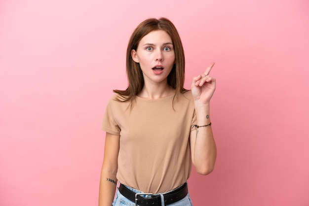 Young English woman isolated on pink background thinking an idea pointing the finger up