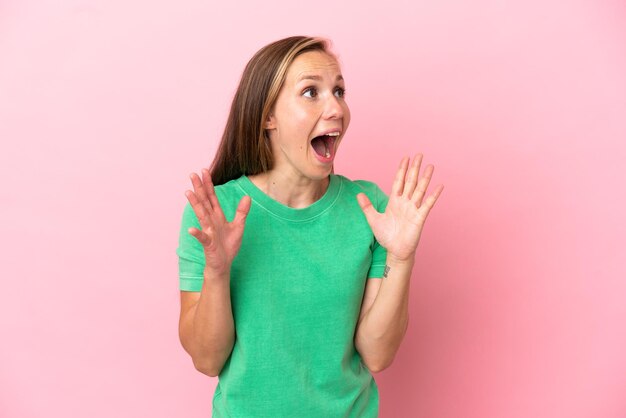 Young English woman isolated on pink background with surprise facial expression