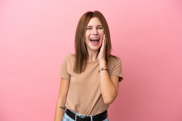 Young English woman isolated on pink background with surprise and shocked facial expression