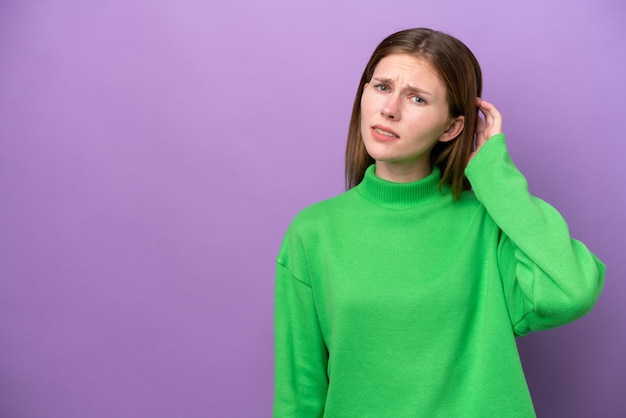 Young english woman isolated on purple background having doubts