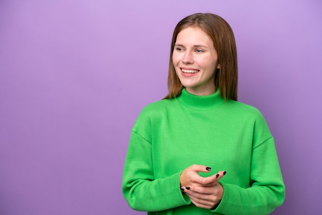 Young English woman isolated on purple background laughing