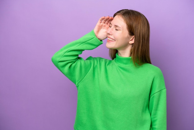 Young English woman isolated on purple background smiling a lot