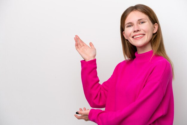 Young English woman isolated on white background extending hands to the side for inviting to come