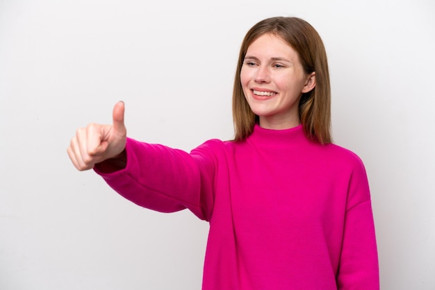 親指を立てるジェスチャーを与える白い背景で隔離の若いイギリス人女性