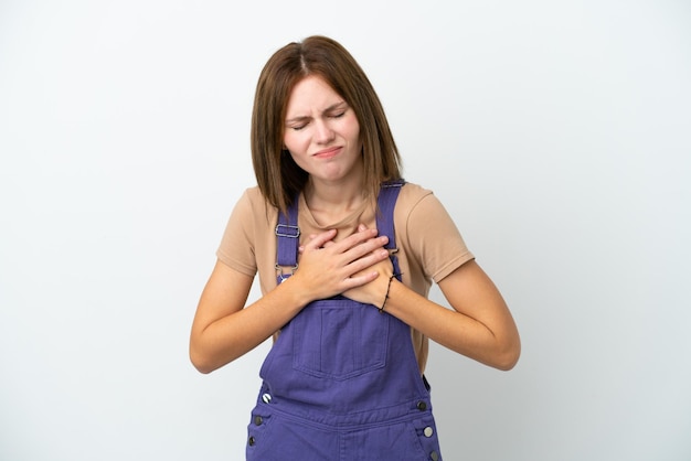 Photo young english woman isolated on white background having a pain in the heart