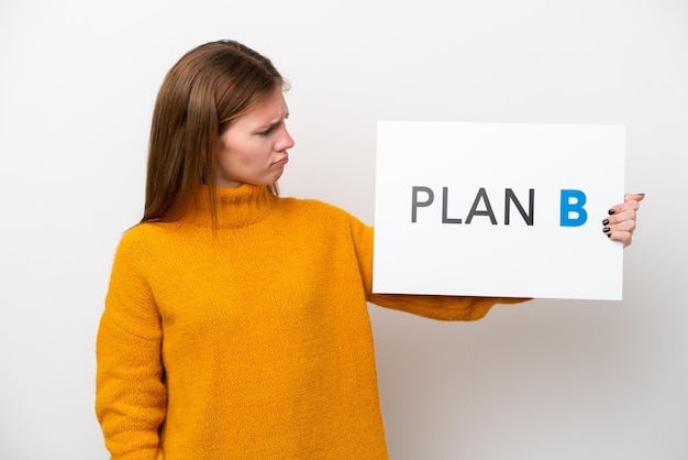 Young English woman isolated on white background holding a placard with the message PLAN B with sad expression