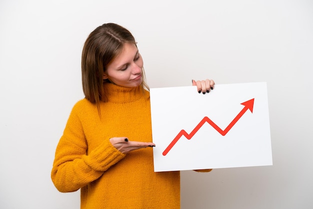 Young english woman isolated on white background holding a sign with a growing statistics arrow symbol and pointing it