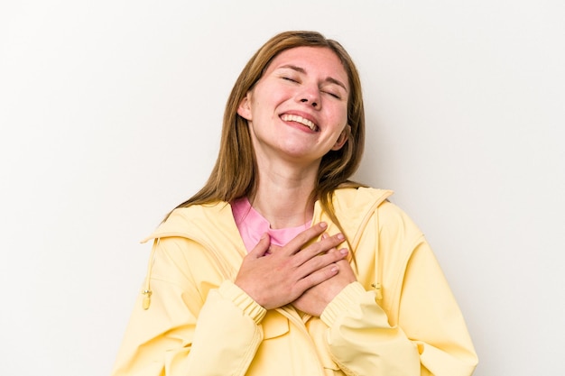 Young English woman isolated on white background laughing keeping hands on heart concept of happiness