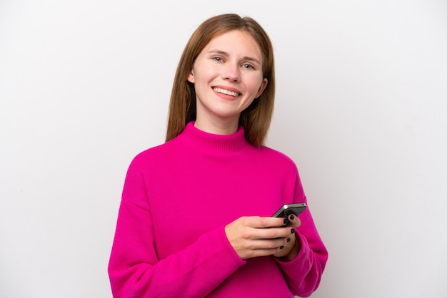 Young English woman isolated on white background sending a message with the mobile